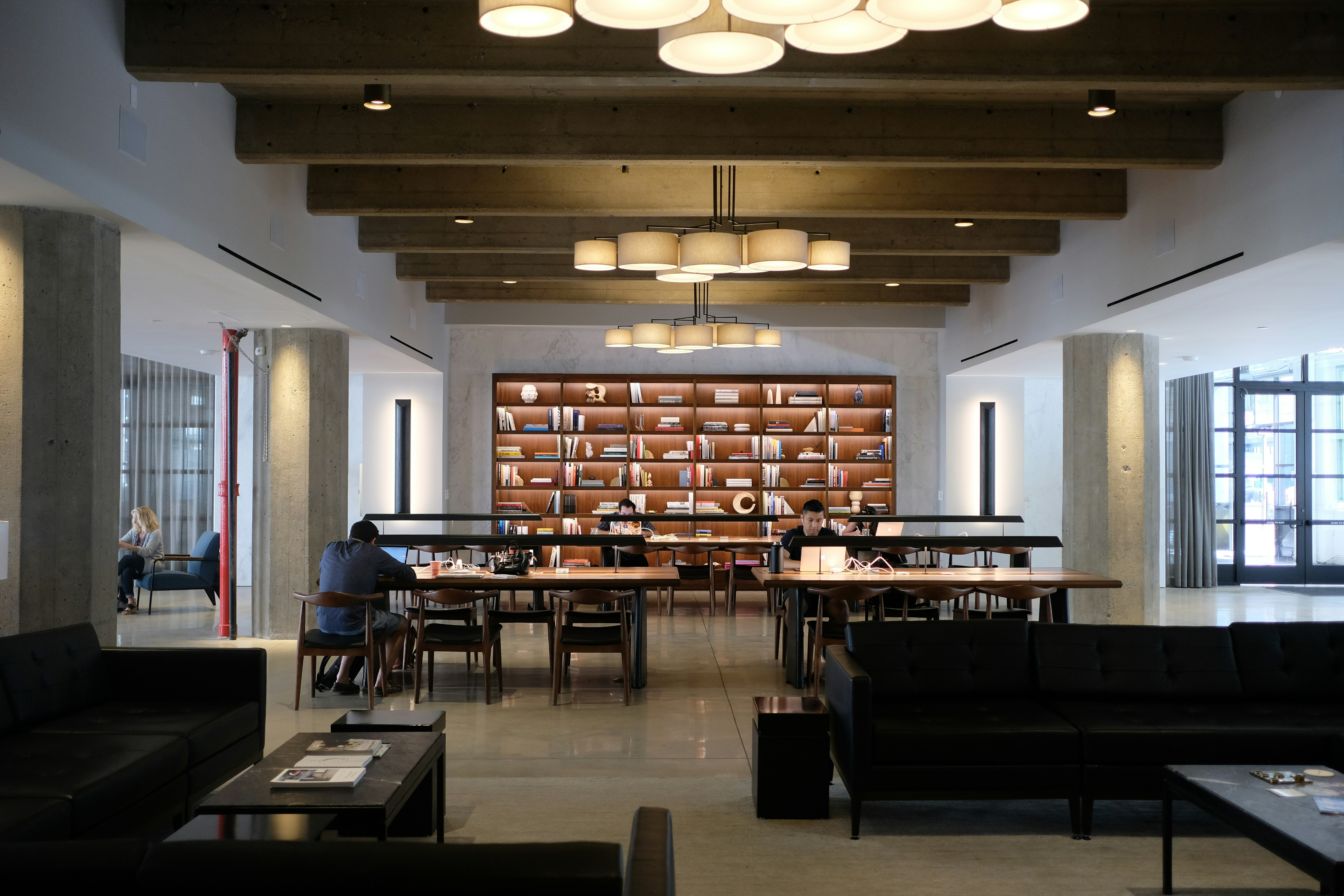 Photo of a study hall area with desks and people studying.
